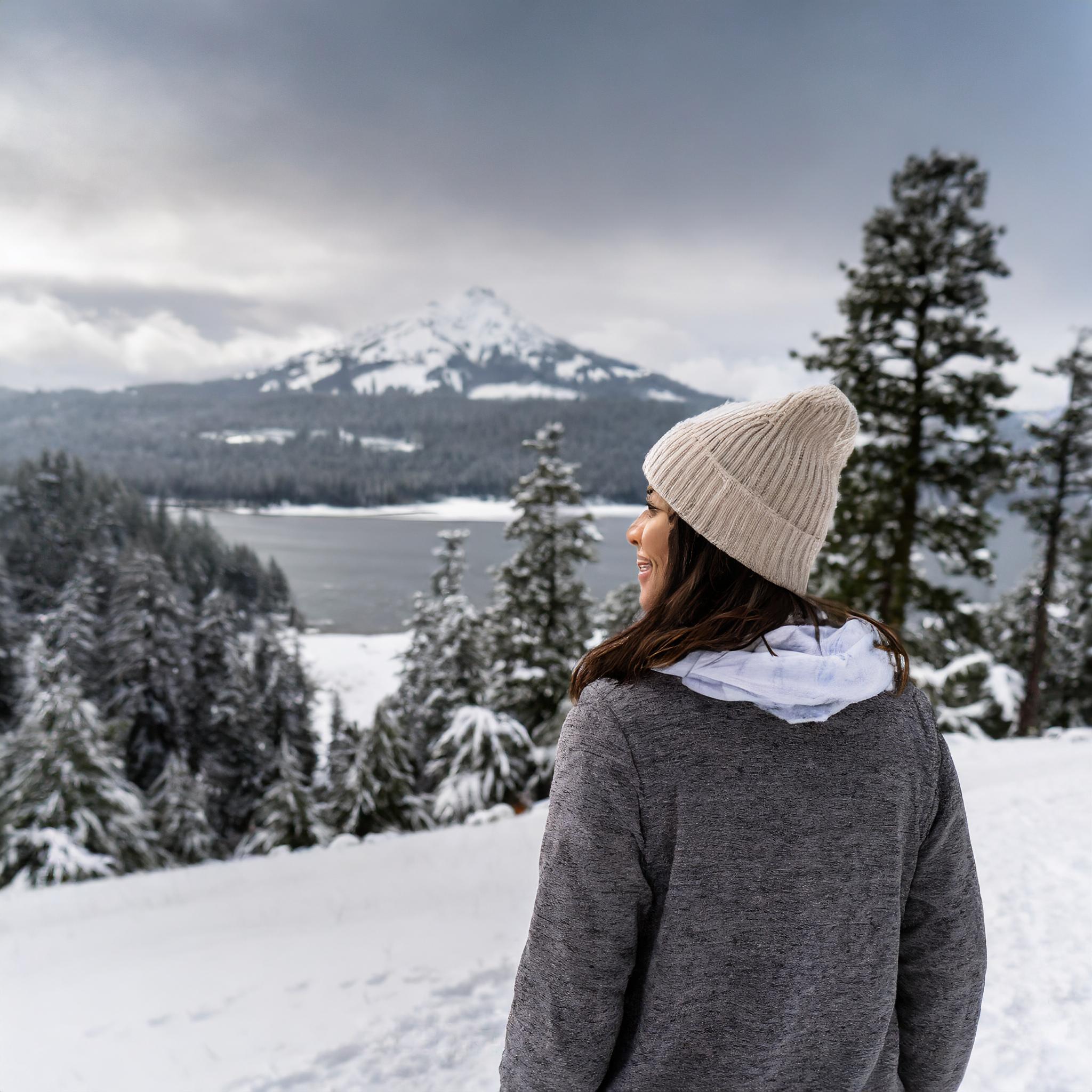 woman in the snow in oregon in the distance cant see her face